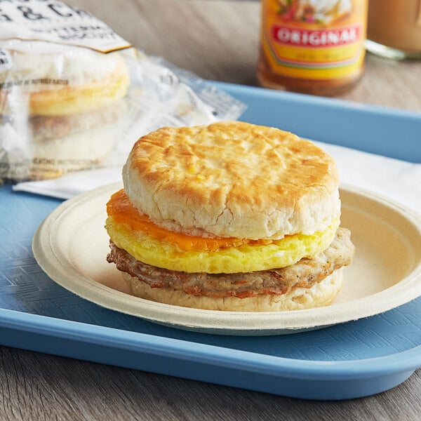A Grand Prairie Sausage, Egg, and Cheese Biscuit Sandwich on a plate.