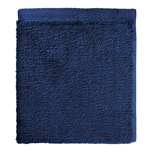 A navy blue 1888 Mills Millenium washcloth with a white border.
