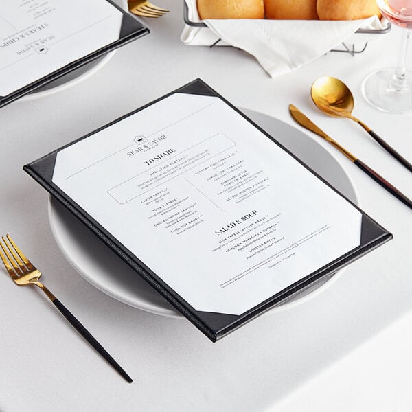 A white table with a black Acopa Prime menu board with a fork and knife.