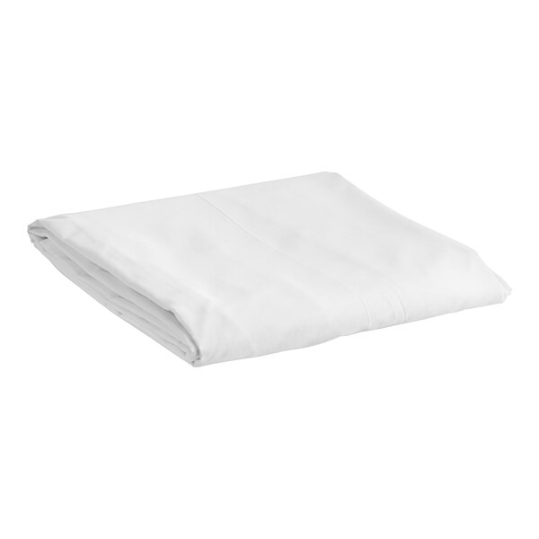 A folded white bed skirt on a white background.