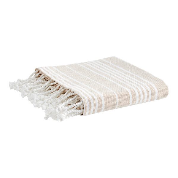A white blanket with tan stripes and fringes.