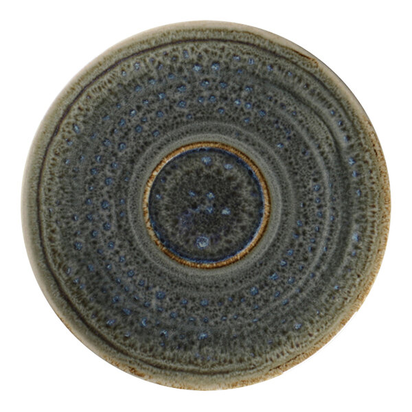 A close-up of a RAK Porcelain peridot espresso cup saucer with a circular design in blue and brown.