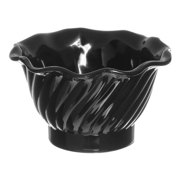 A black Dinex plastic bowl with wavy lines.