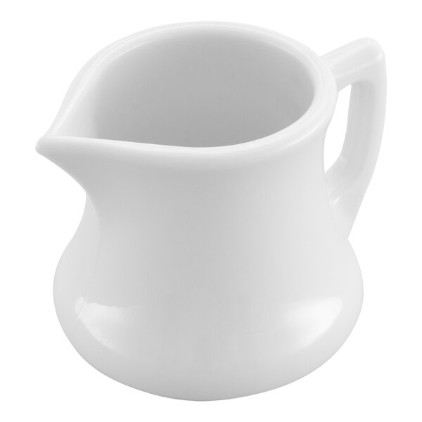 A close up of a white Carlisle plastic creamer with a handle.