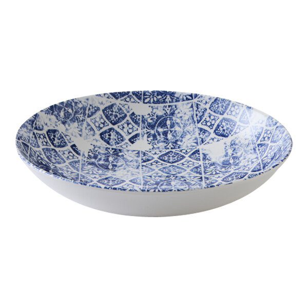 A white china bowl with a blue pattern on the inside.