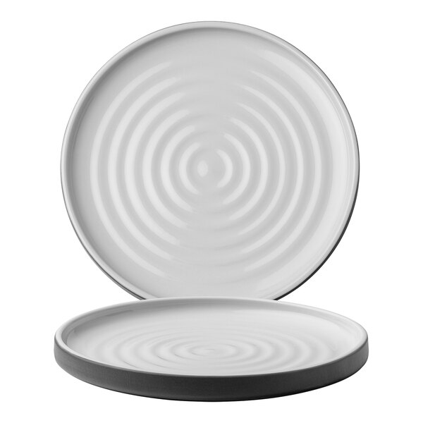 A white Chef & Sommelier stoneware plate with a spiral pattern on the rim.