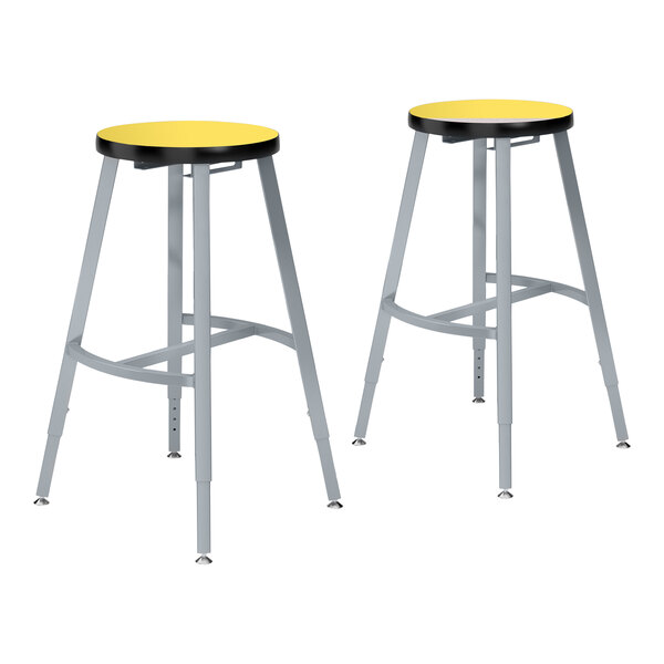 Two National Public Seating Titan lab stools with metal legs and yellow high-pressure laminate seats.