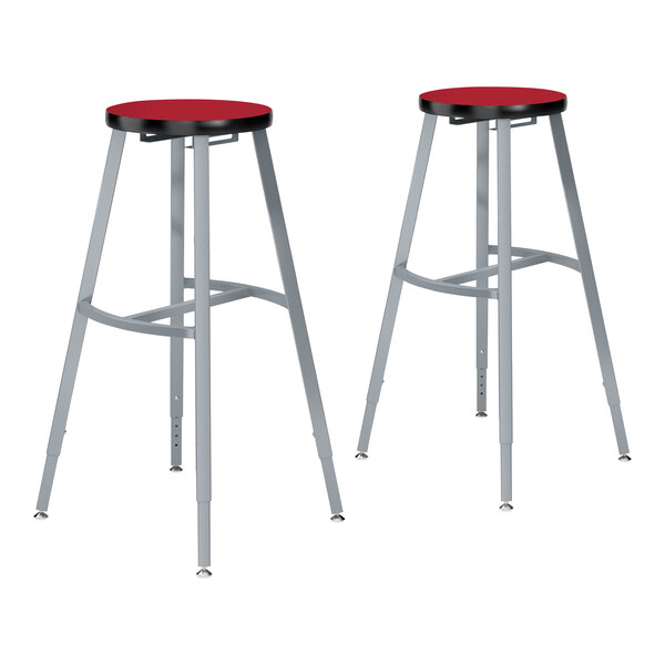 Two National Public Seating gray steel lab stools with hollyberry high-pressure laminate seats.