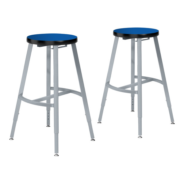 A pair of National Public Seating lab stools with blue high-pressure laminate seats and metal legs.