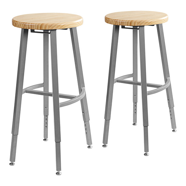 Two National Public Seating steel lab stools with oak seats.