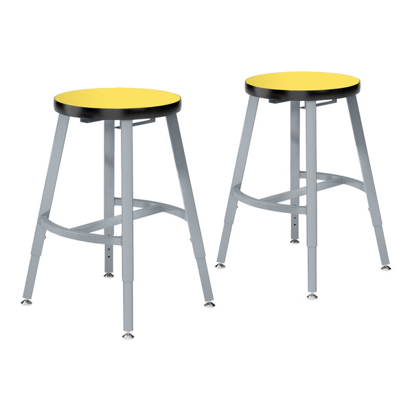 Two National Public Seating Titan lab stools with black legs and a marigold seat.