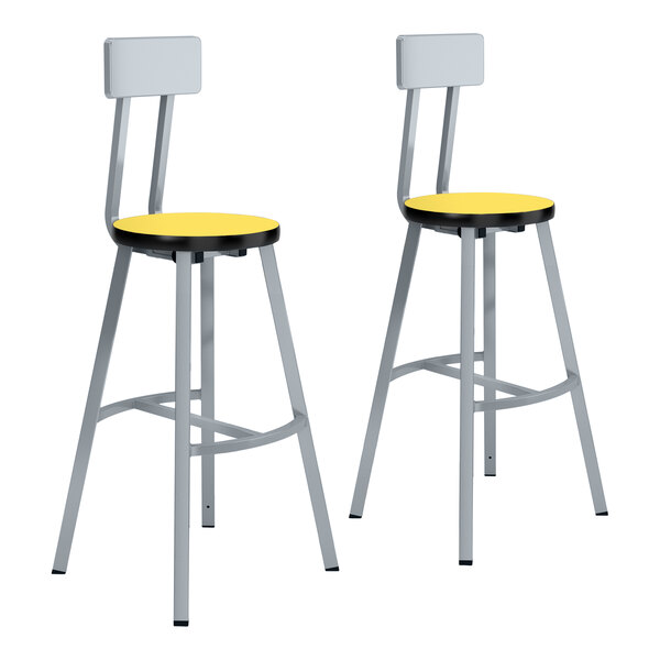A pair of National Public Seating lab stools with marigold seats and gray legs.