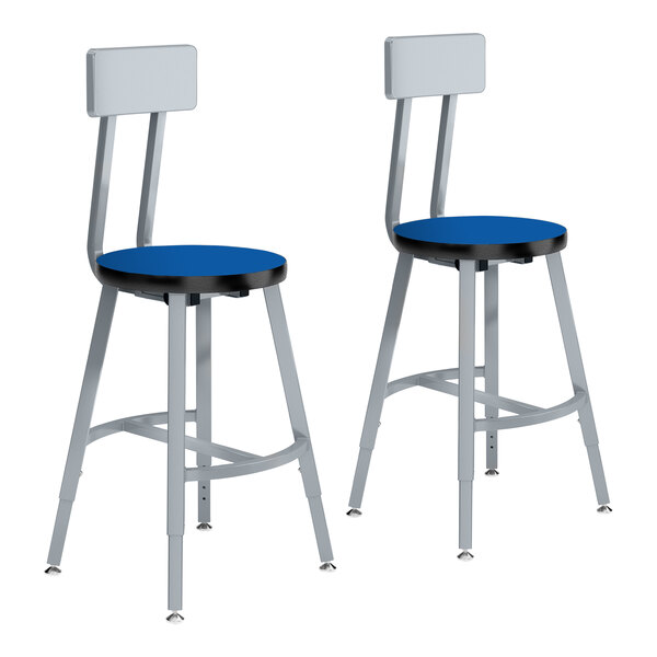 A pair of National Public Seating lab stools with blue seats and metal legs.