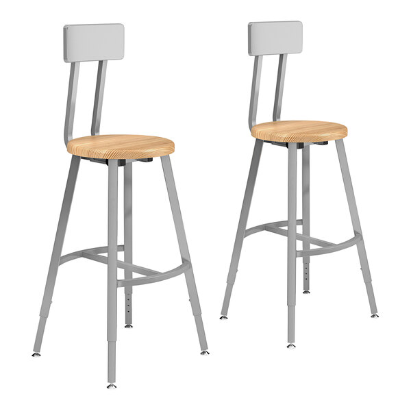 A pair of National Public Seating lab stools with gray steel frames and oak seats.