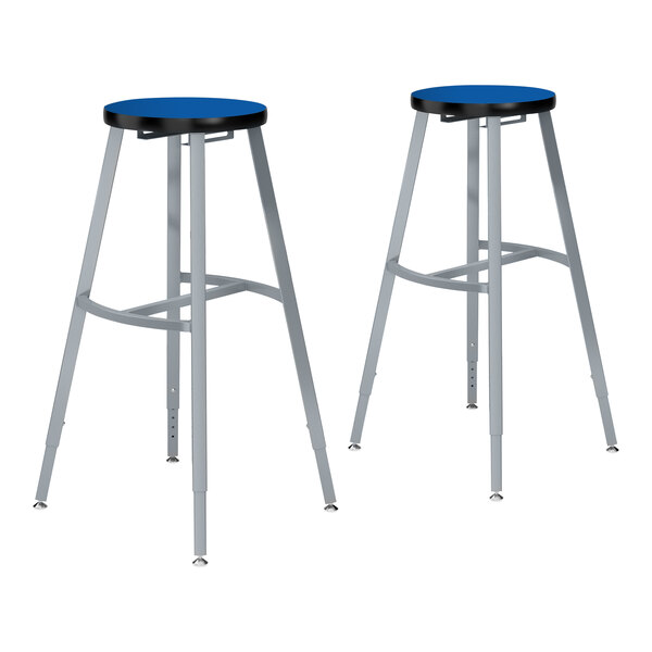 A pair of National Public Seating lab stools with Persian Blue seats on metal legs.