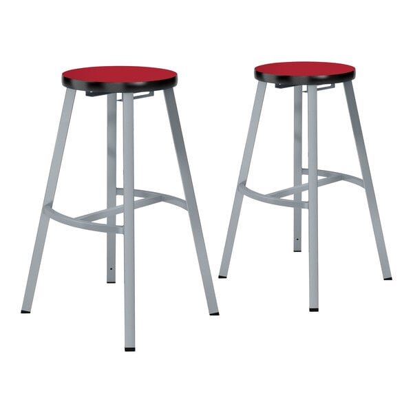 Two gray steel lab stools with hollyberry high-pressure laminate seats.