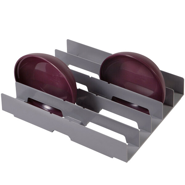 A grey plastic Cambro Camshelving® dome drying cradle with purple plates and bowls.