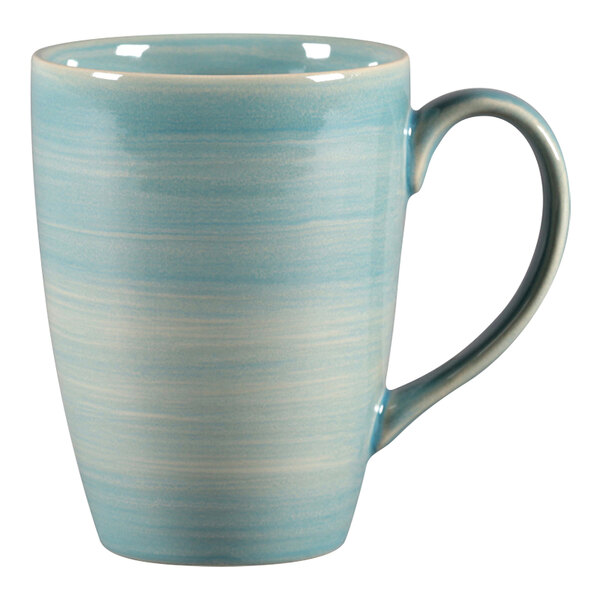 A close-up of the handle of a blue and white RAK Porcelain coffee mug.