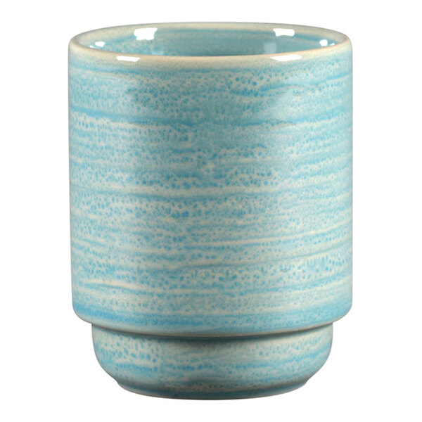 A close up of a blue and white RAK Porcelain mug with a white rim.