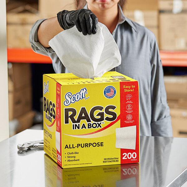 A woman holding a yellow Scott Rags in a Box.