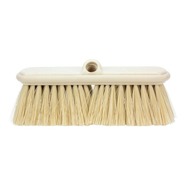 A white Carlisle janitorial brush with a long handle.