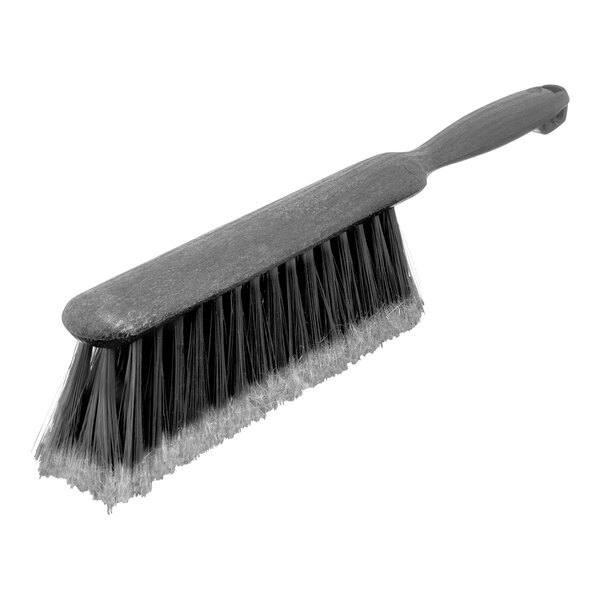 A close-up of a Carlisle gray polypropylene counter brush with flagged bristles.