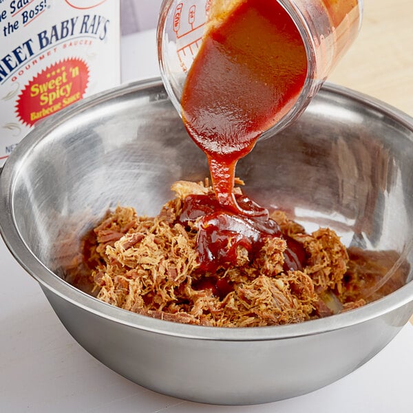 A bowl of Sweet Baby Ray's Sweet 'n Spicy BBQ Sauce being poured into a bowl.