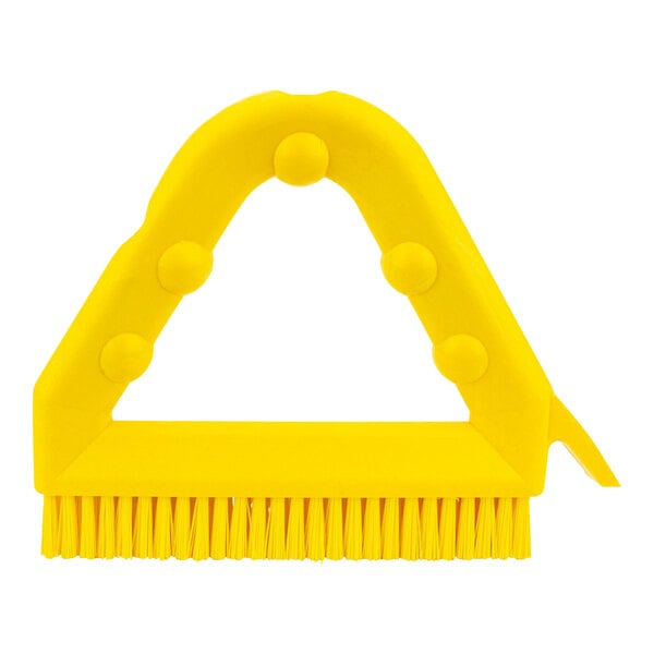 A yellow Carlisle Sparta Spectrum grout brush with a scraper.