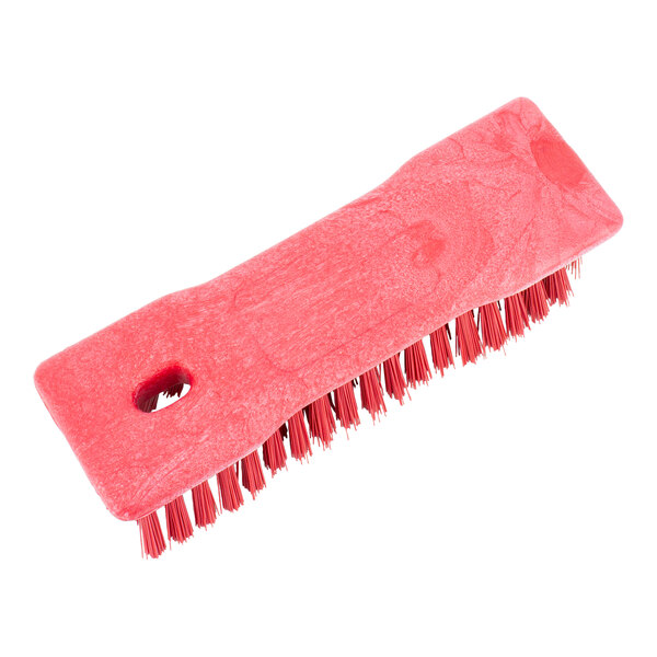 A red Carlisle Sparta handheld scrub brush with black bristles.