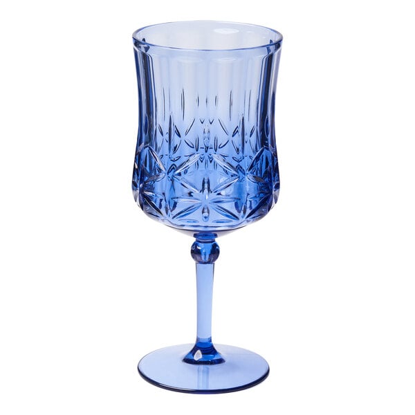 A Sophistiplate cobalt blue wine glass with a design on it.