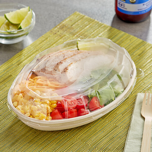 A Stalk Market plastic dome lid on a plastic container with salad.