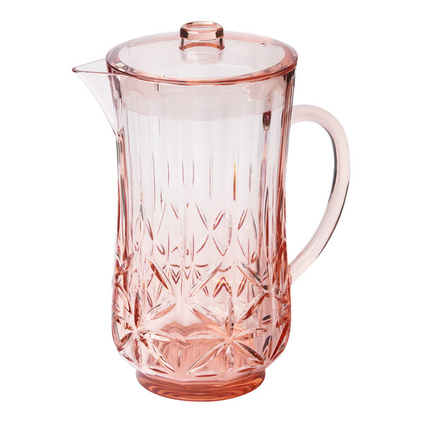 A Sophistiplate blush pink plastic pitcher with a handle and lid.