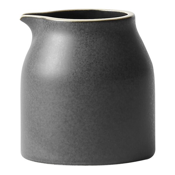 A black ceramic pitcher with a white rim and handle.