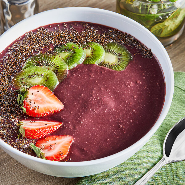 A bowl of smoothie with strawberries, kiwi, and Pitaya Foods Organic Sweetened Acai Berry Bite-Sized Pieces.