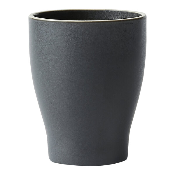 A close up of a black Oneida Moira stoneware tumbler with a gold rim.
