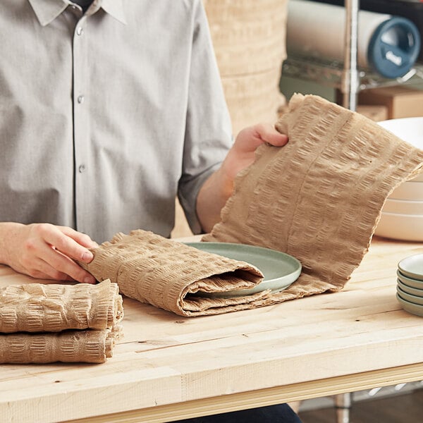 A man using ecoMAX Care cellulose wadding to pack a plate.