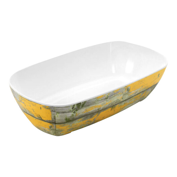 A white bowl with a yellow rim and interior, on a counter.