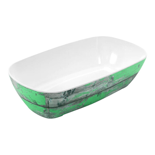 A white bowl with a green rim and interior on a counter in a salad bar.