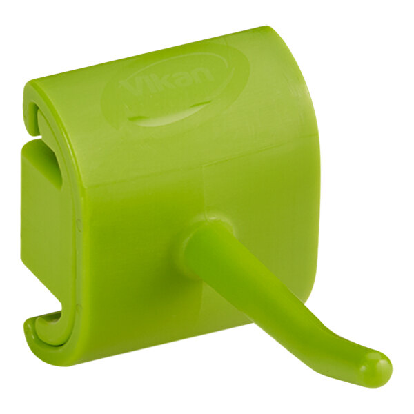 A green plastic Vikan wall bracket with a hook.