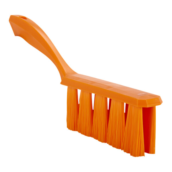 An orange Vikan bench brush with soft bristles and an orange plastic handle.