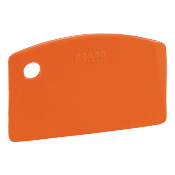 An orange plastic Remco bench scraper with a white circle on the handle.