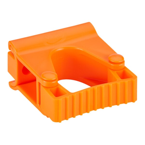 An orange plastic Vikan wall bracket.