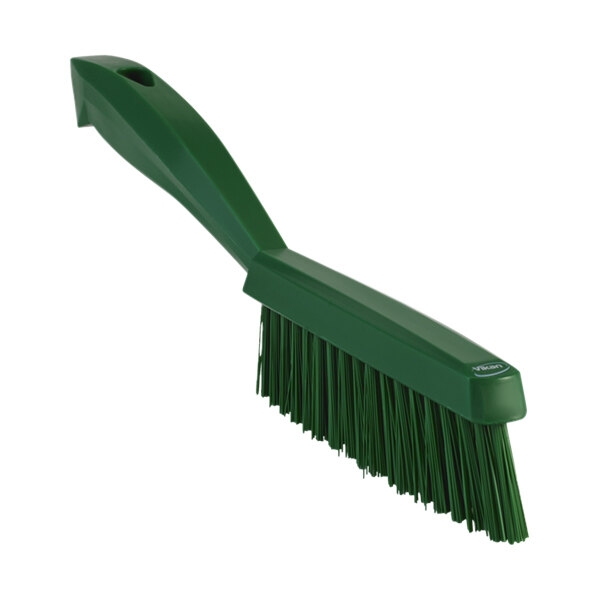A green Vikan narrow hand brush with a short handle.