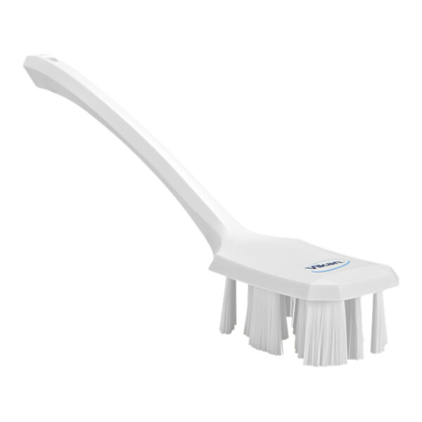 A white Vikan hand brush with a long handle.
