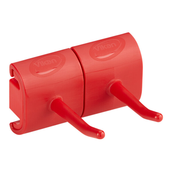 A red Vikan wall bracket with two hooks.