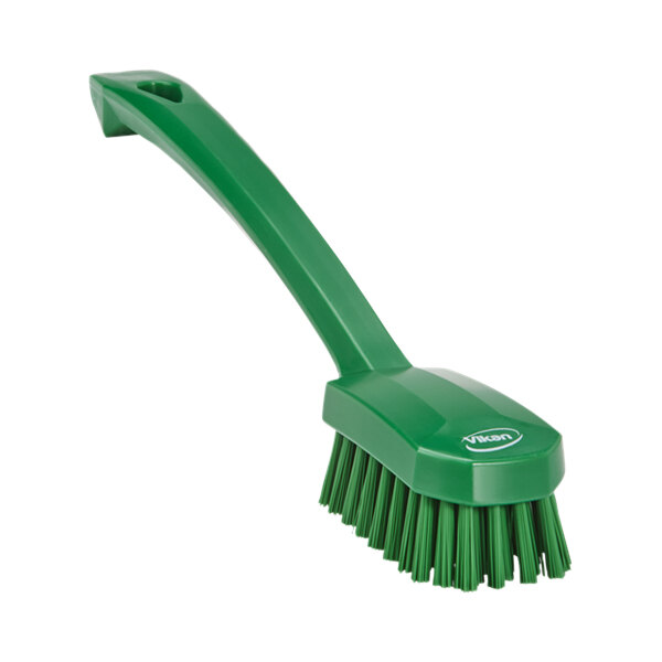 A green Vikan utility brush with a handle.