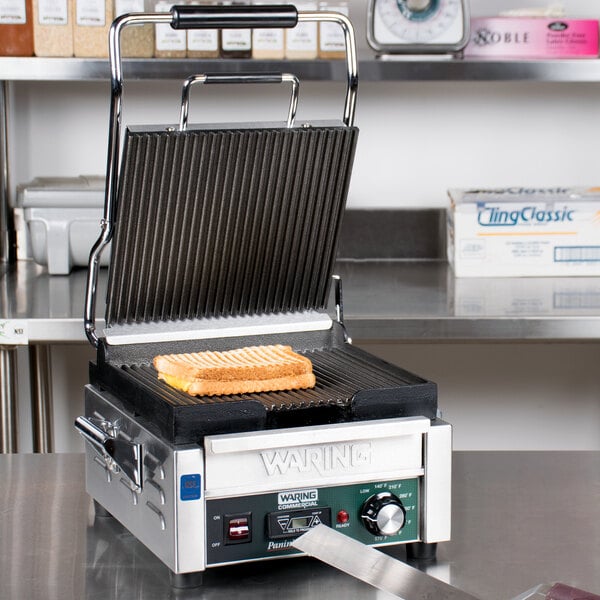 A sandwich cooking on a Waring Panini Perfetto grill.