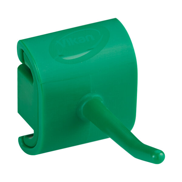 A green plastic Vikan single hook for a wall bracket.