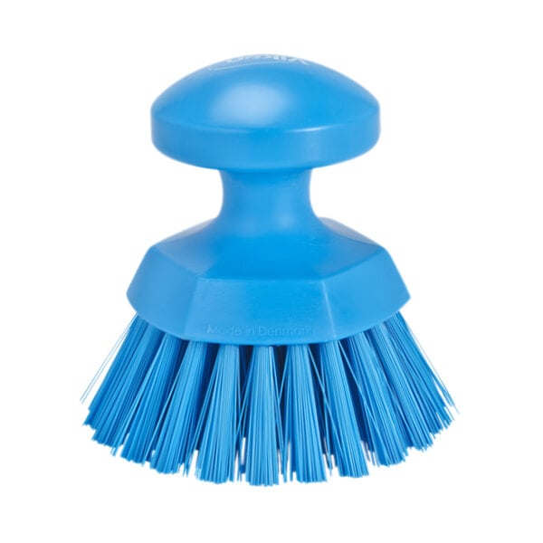 A blue circular Vikan scrub brush with a round handle and stiff bristles.