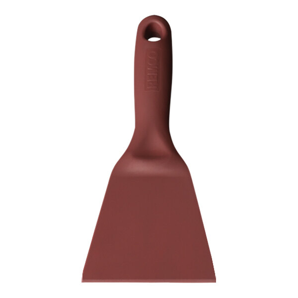 A red Remco metal detectable hand scraper with a hole in the handle.
